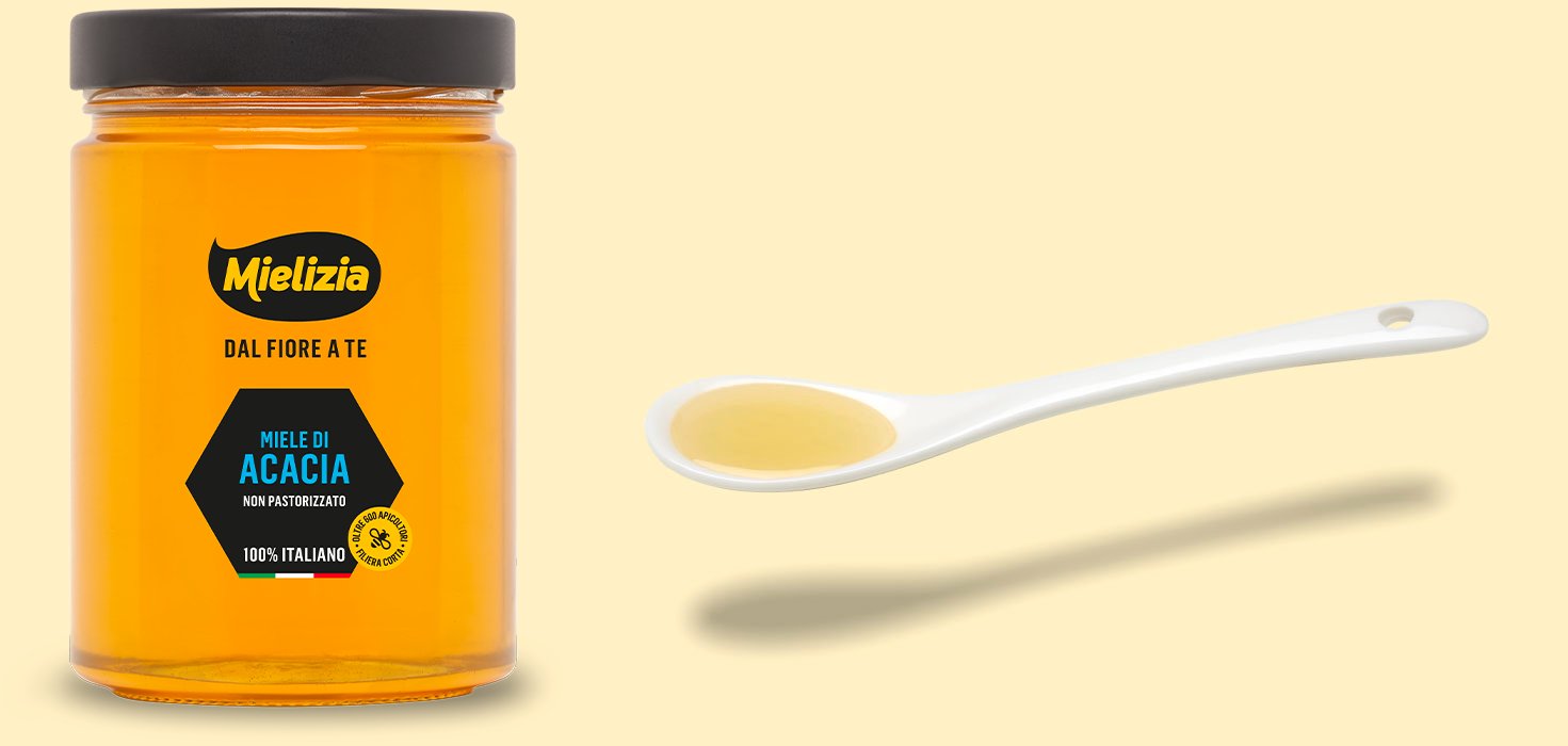 Pot de miel d'acacia avec cuillère